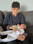 Posted Oct.23: Wally Chin happily poses with his first grandchild – a boy – born earlier this year.