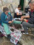 Locals cleaning barnacles. Saw them offered on a buffet. Not interested, thanks