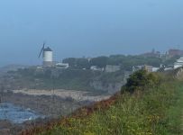 Typical Spanish coastal town. Old windmills survive in Spain and Portugal.