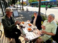 Yves Bournival captured (L-R) Robert Groulx, Pascal Guillon and Robert Zaitman at Tommy Haas Cafe on W. Broadway in June.  They meet there usually once per month on a Thursday.